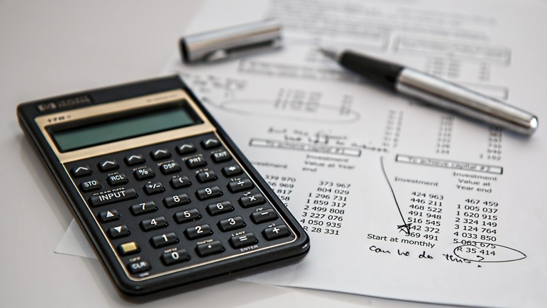 Calculator on top of a paper full of numbers